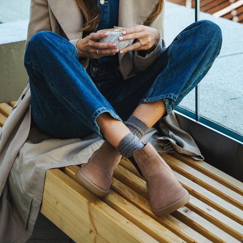 Woman resting on a bench in barefoot ankle shoes