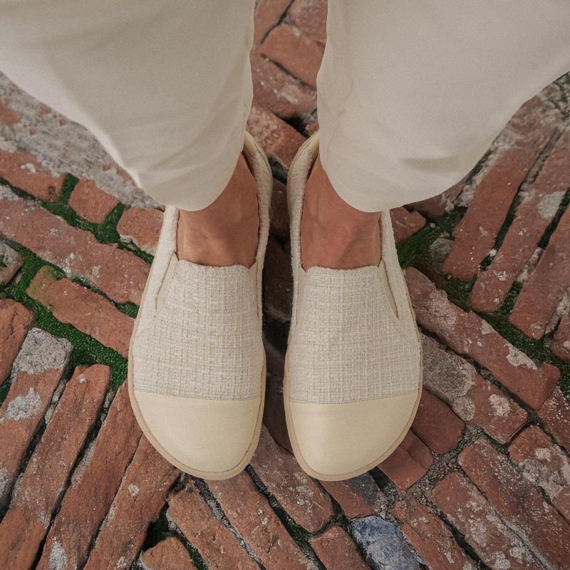 Ivory barefoot slip-on shoes on brick paving
