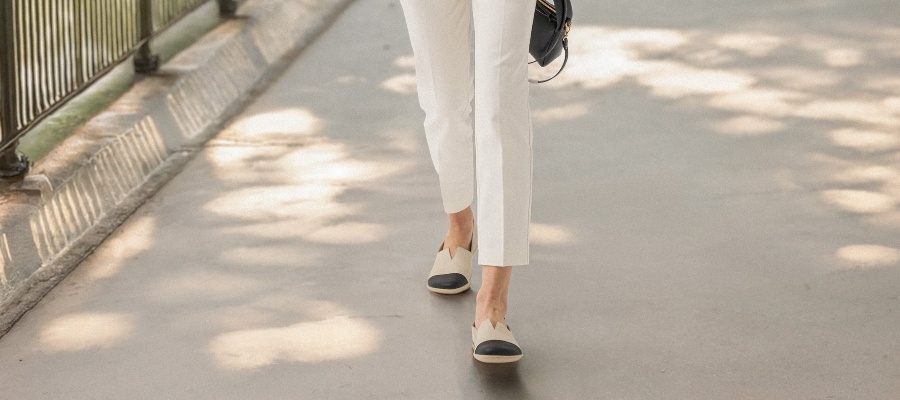 Light beige barefoot loafers while walking on a pavement