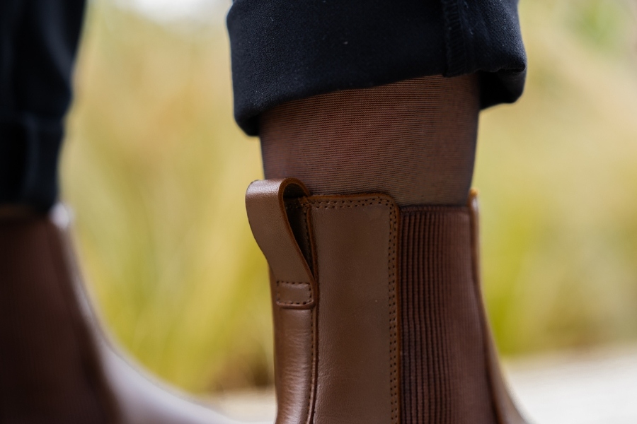 Close-up of brown women's Chelsea barefoot boots with an elastic side panel
