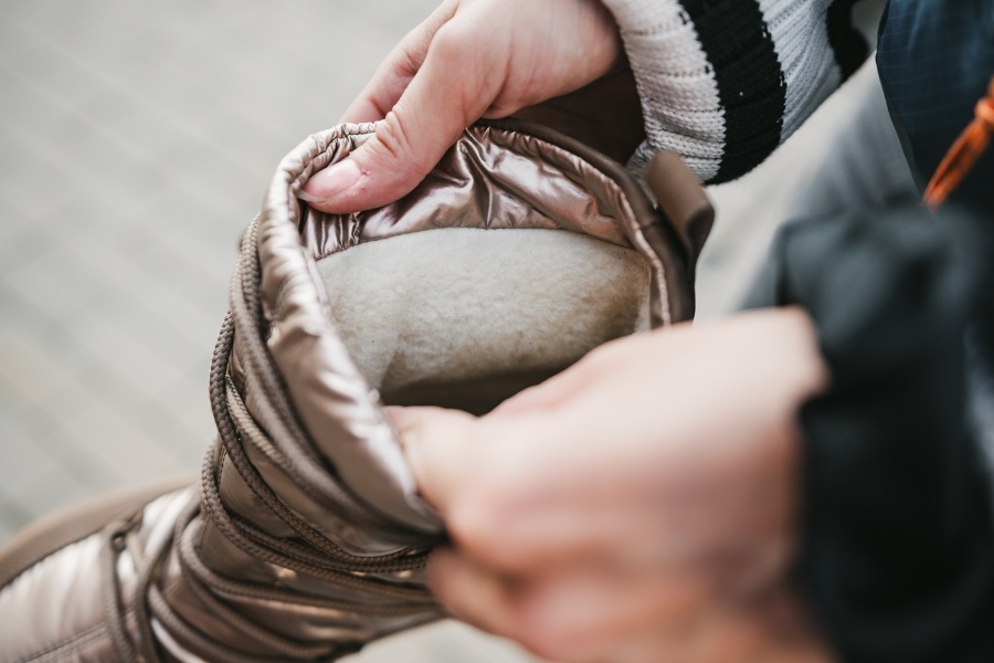 Close-up of the insulated lining of a beige women's barefoot snow boot