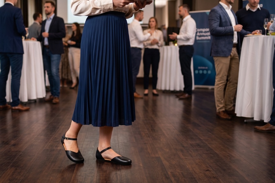 Woman in black women's office barefoot shoes at a corporate event