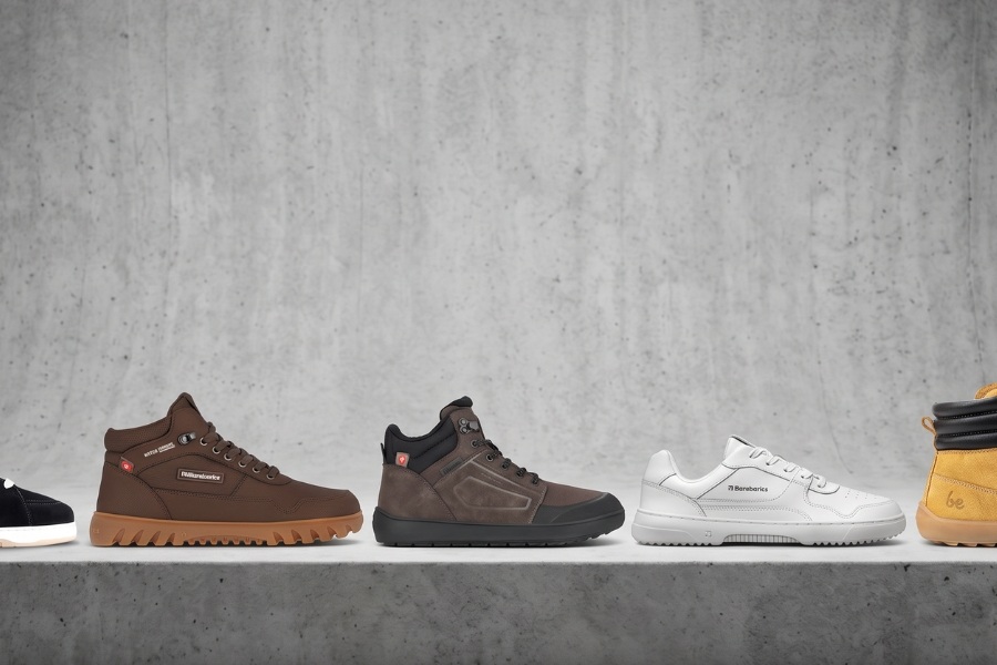 Selection of men's barefoot shoes lined up in different models on a concrete ledge Selection of men's barefoot shoes lined up in different models on a concrete ledge