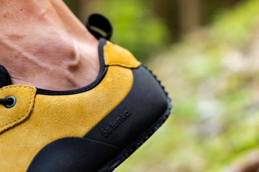 Close-up of a yellow suede men's outdoor barefoot shoe with a chunky sole Close-up of a yellow suede men's outdoor barefoot shoe with a chunky sole