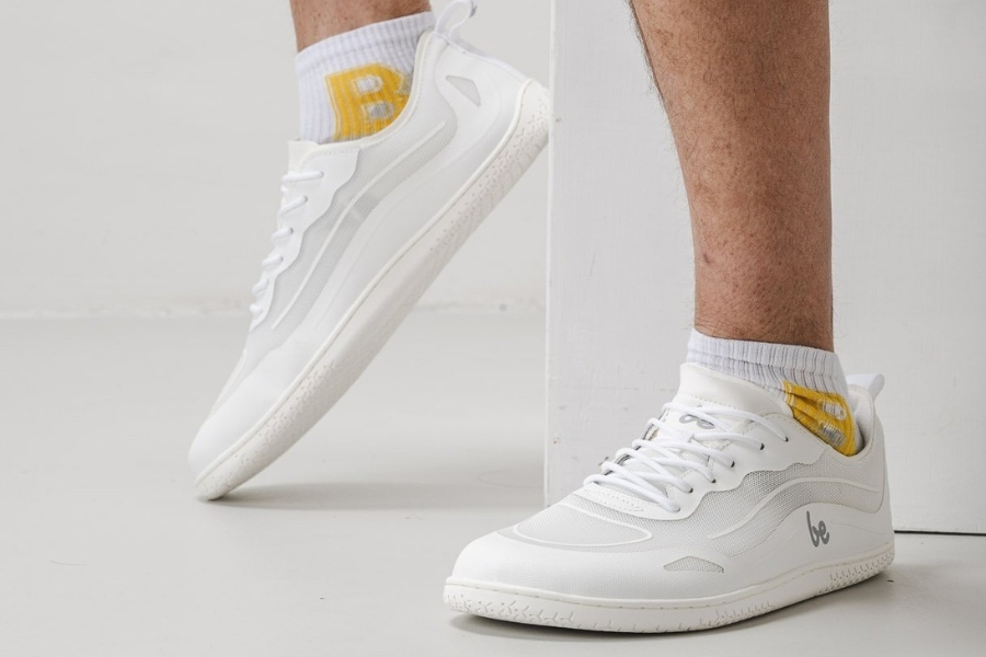 Close-up of feet in white men's sports barefoot shoes with white socks