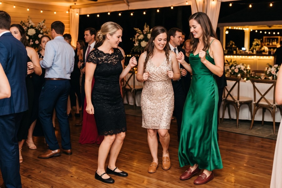 Guests dancing at a wedding reception in black and cognac barefoot wedding shoes. Guests dancing at a wedding reception in black and cognac barefoot wedding shoes.